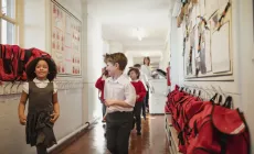 happy school children walking in a hallway