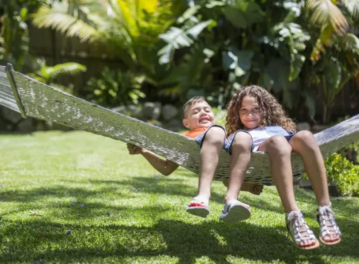 boy and girl swinging on outdoor hammock